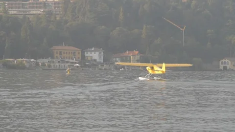 Yellow floatplane is floating on the water. Lake Como Video stock 127823522