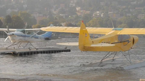 Yellow floatplane gets into the water for the flight in the Lake Como Video stock 127823676