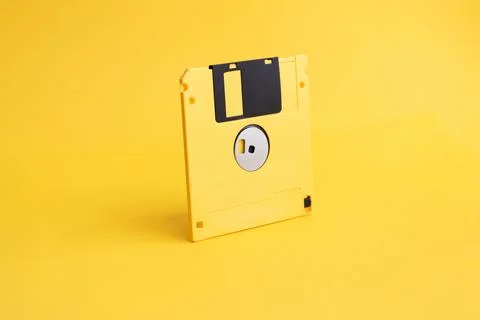 Yellow floppy disk on yellow background Stock Photos