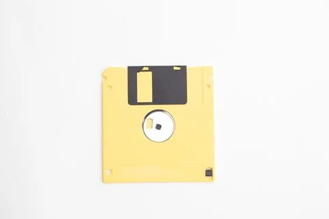 Yellow floppy diskette on white background Foto stock