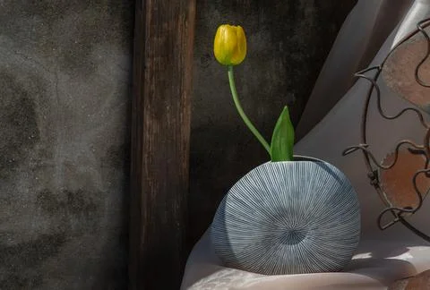 Yellow flower in Blue shell shape ceramic vase on pink textured table cloth. Stockfoto's
