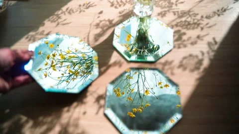 Yellow flowers are reflected in the mirror. the mirror catches the glare. Man Stock-Footage 134034914