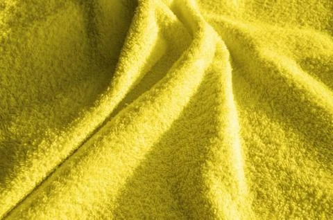 Yellow fluffy Terry towel, a simple example of the texture of a soft, fleecy  Stock Photos