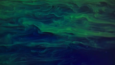 Yellow fluorescent paint waves and floats in slow motion Stock Footage 124807382