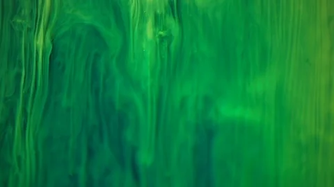 Yellow fluorescent paint waves and floats in slow motion Stock Footage 124807386