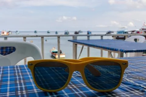Yellow frame sunglasses on table Stock Photos