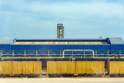 Yellow Freight Train Containers at Blue Industrial Warehouse Facility with .. Fotos Stock