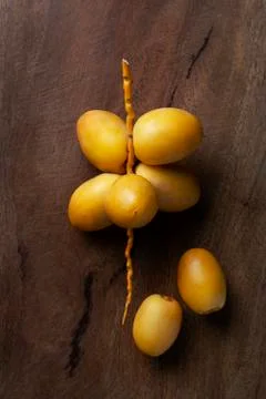 Yellow fresh dates fruit isolate on wooden background Stock Photos