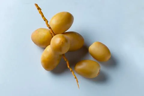 Yellow fresh dates fruit isolate on white background Stock Photos