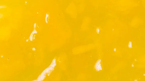 Yellow fruit jam textured background, stop motion Stock Footage 125445148