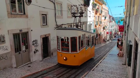 Yellow Funicular Approaching on Steep Graffiti Street, Lisbon, Portugal 8K 스톡 동영상 249975478