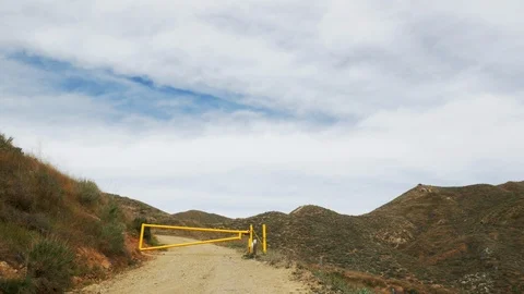 Yellow Gate Keeps Out Unwanted Visitors On Dirt Road Stock Footage 125644917