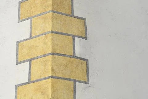 Yellow geometric pattern on building corner facade Foto stock