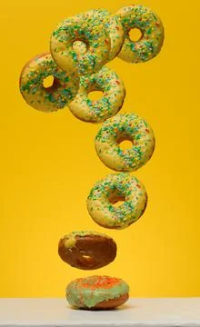 Yellow glazed donuts, each decorated with multi colored sprinkles. Stock Photos