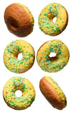 Yellow glazed donuts, each decorated with multi colored sprinkles. Stock Photos