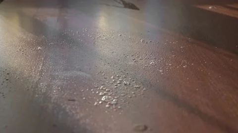 Yellow-gloved hand spray detergent on the table and wipe it down Stock Footage 149458786