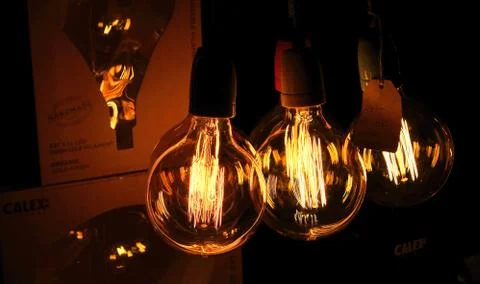 Yellow glowing bulbs in the dark Stock Photos