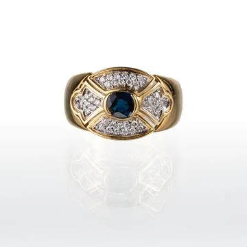 Yellow gold ring with a central blue sapphire Stock Photos