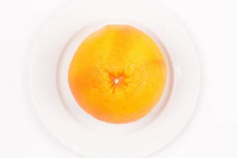 Yellow grapefruit on a plate Stock Photos