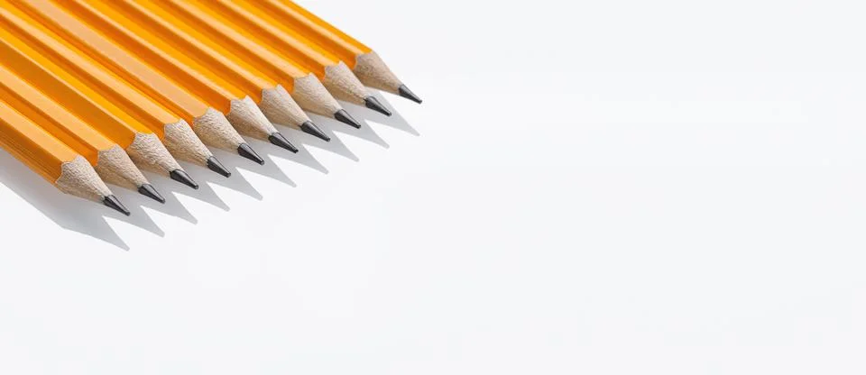 Yellow graphite pencils with sharp tips lined up on a white background. Gre.. Stock Photos