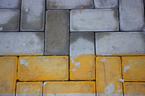 Yellow gray brick wall texture of a parking lot for background Foto stock