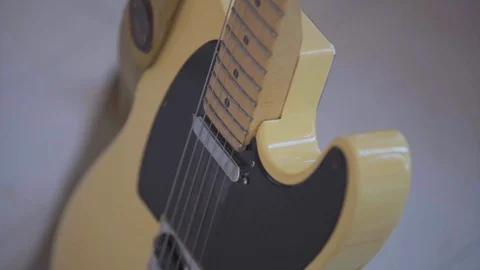 Yellow guitar with black and silver strings close-up 스톡 동영상 103469953