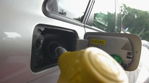 Yellow gun for refueling the car is pulled out of the tank Stock Footage 77235685