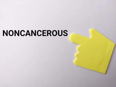 A yellow hand-shaped note points directly toward the bold text NONCANCEROUS.. Stock Photos