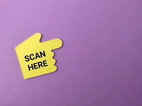 A yellow hand-shaped pointer cutout with the words SCAN HERE against a purp.. Stock Photos