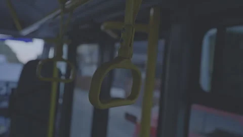Yellow handrails inside empty bus during early evening Video stock 281763762