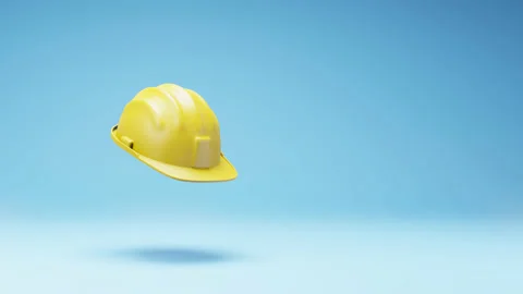 Yellow Hard Hat Spinning on Studio Blue Background Stock Footage 236225835