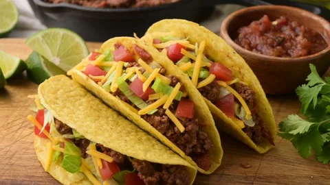 Yellow hard shell tacos on cutting board Stock Footage 274107635