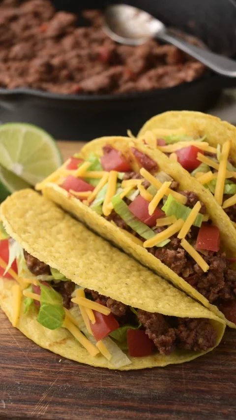 Yellow hard shell tacos on cutting board Stock-Footage 274107974