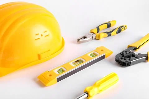Yellow hardhat and construction tools isolated on white background Stock Photos