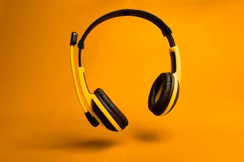Yellow headset on orange background Foto stock