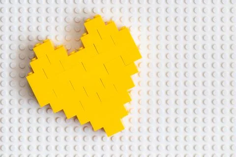 Yellow heart made from Lego blocks for design purpose Stock Photos