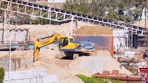 Yellow heavy excavators operating at an industrial construction quarry site Stock Footage 345938416
