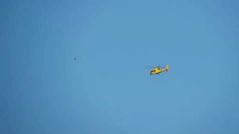Yellow helicopter in the air Stock Footage 83034244