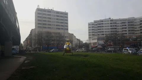 Yellow helicopter, rotor in motion before takeoff, Kottbusser Tor, Berlin Видео 76497632