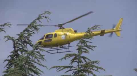 Yellow helicopter in slow motion Stock Footage 40012495