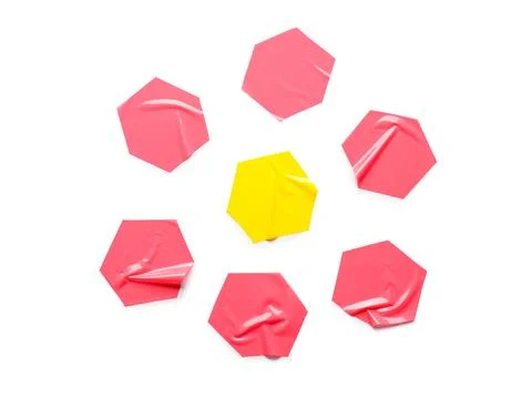 Yellow hexagon surrounded by red hexagons on white background Stock Photos