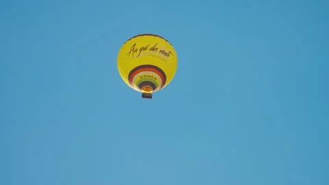 Yellow Hot Air Balloon Floating Across Clear Blue Sky Stock Footage 346852254