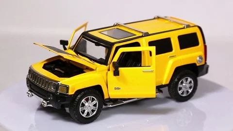 Yellow Hummer H3 scale model SUV car with opened doors and hood is rotating. Stock Footage 101774035