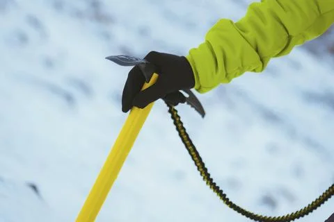 Yellow ice axe in the snow Stock Photos