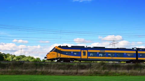 Yellow ICNG Train Moving Along Tracks in Netherlands Stock Footage 344395297