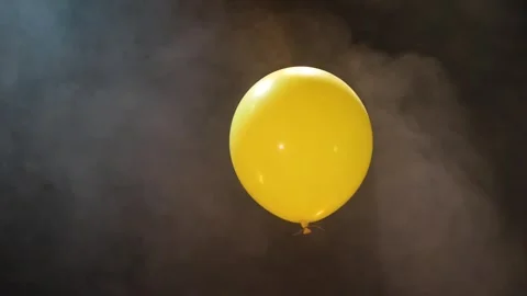 Yellow Inflatable Ball on a Dark Background With Smoke Stock Footage 244466129