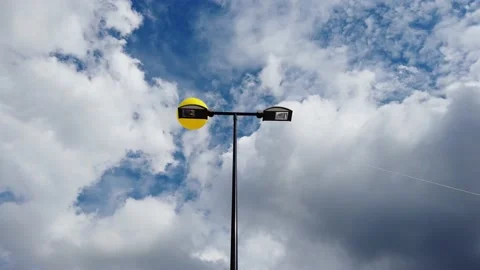 Yellow inflatable balloon moving around streetlamp outdoors Stock-Footage 138145406