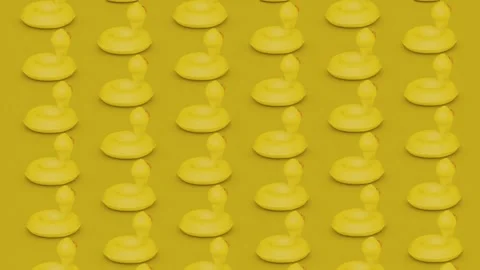 Yellow inflatable ducks spinning around their axis 3d rendered animation Stock Footage 301903164
