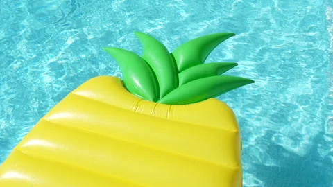 A yellow inflatable pool float with a green leaf on top Stock Footage 278000981