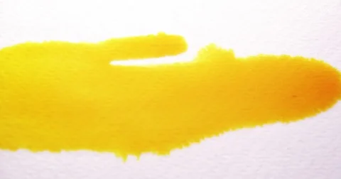 Yellow ink spill on white surface paper Stock Footage 81487065
